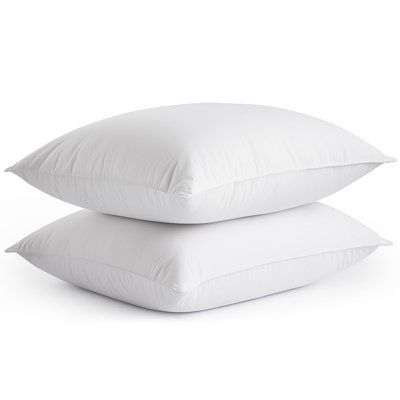 two pillows stacked on top of each other, one is white and the other is plain