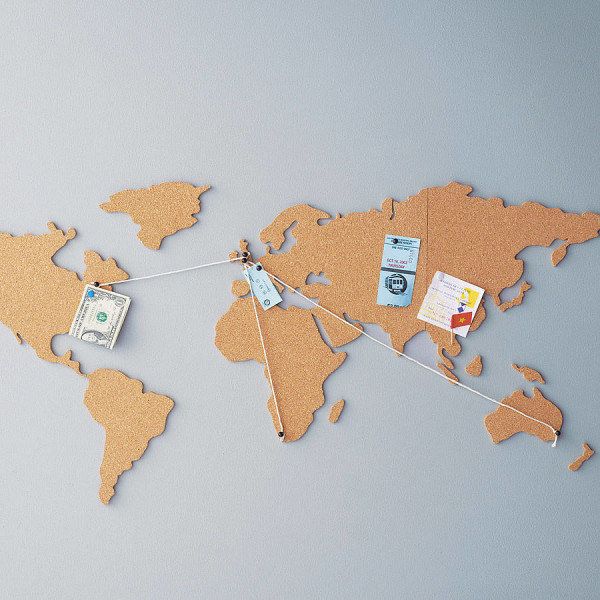 the world map is made out of cork and has money tied to it with clothes pins