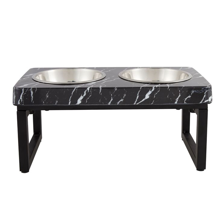 two bowls on a black and white marble dog bowl stand with metal legs for dogs to drink from