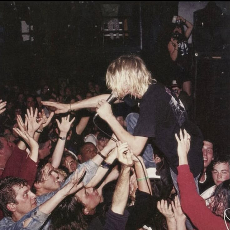 a group of people reaching up in the air