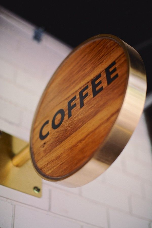 a wooden sign that says coffee on it