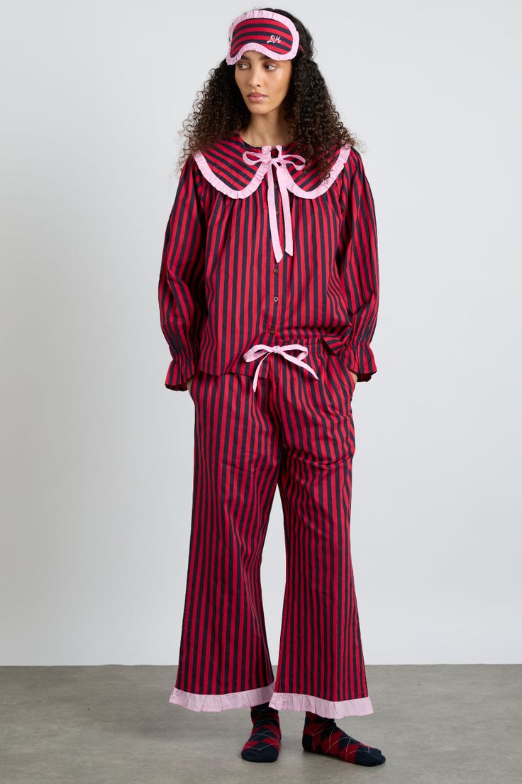 Red and navy stripes adorn our Maria pyjama set, trimmed with baby pink and cropped at the leg. If you're feeling extra, match these with our corresponding eye mask. • Top and bottoms • Matching bag included • Oversized collar • Button fastening at back • Cropped leg • Elasticated waist with functional tie • 100% organic cotton • Designed in London MODEL INFO: Model is 5'10 and is wearing a UK 8. Crochet Stripe Scarf, London Models, Oversized Collar, Checked Scarf, Striped Pyjamas, Hooded Scarf, Striped Scarves, Pink Gingham, Striped Cardigan