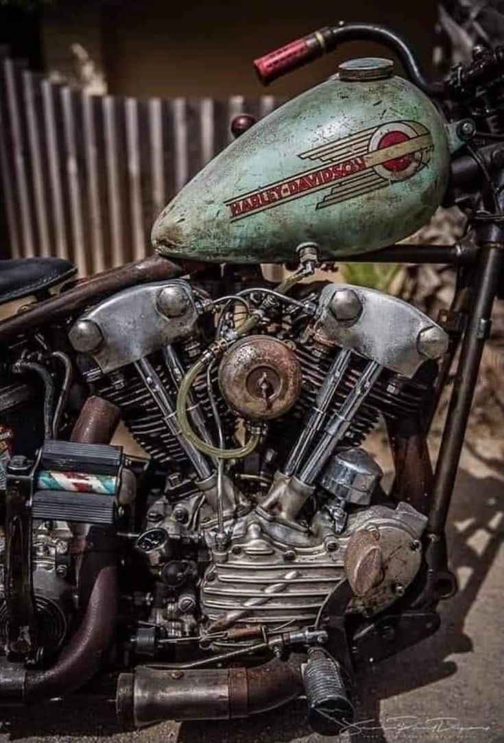 an old motorcycle is parked on the street