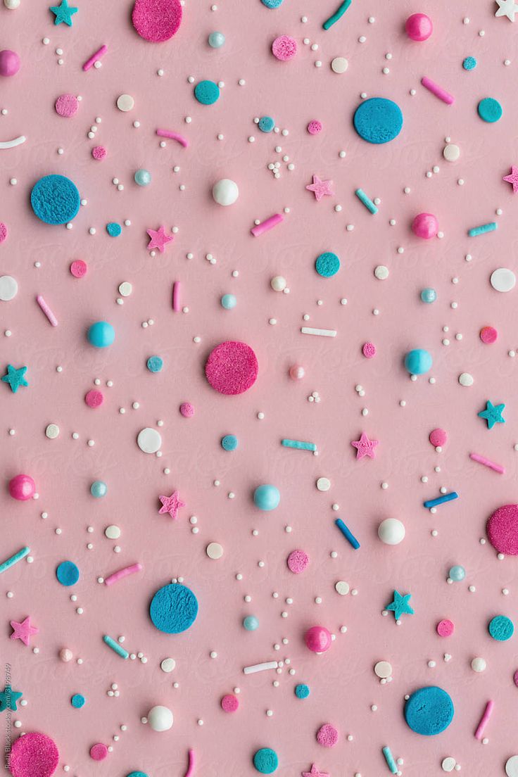 pink, blue and white confetti on a pink background