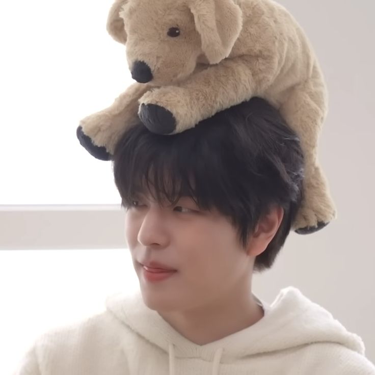 a man with a teddy bear on his head