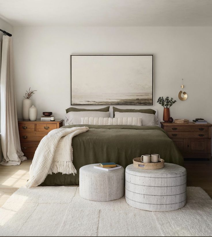 a bedroom with a large bed and two stools on the floor next to it