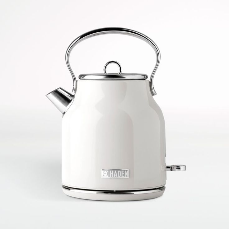 a white tea kettle sitting on top of a table