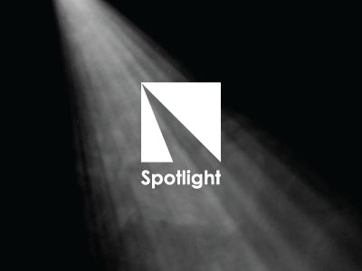 spotlight logo on black and white background with light coming from the top right corner in front of it