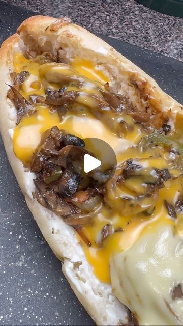 a hot dog covered in cheese and toppings