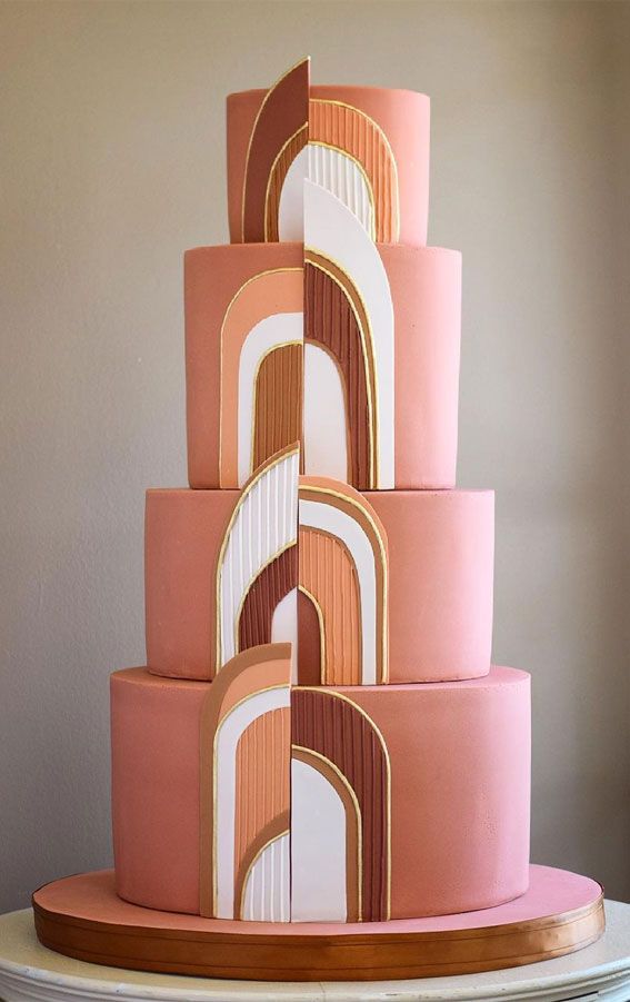 a three tiered cake with geometric designs on it