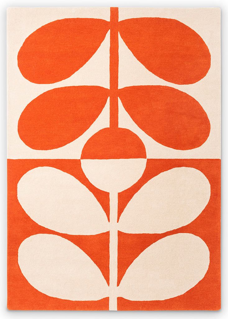 an orange and white rug with flowers on it