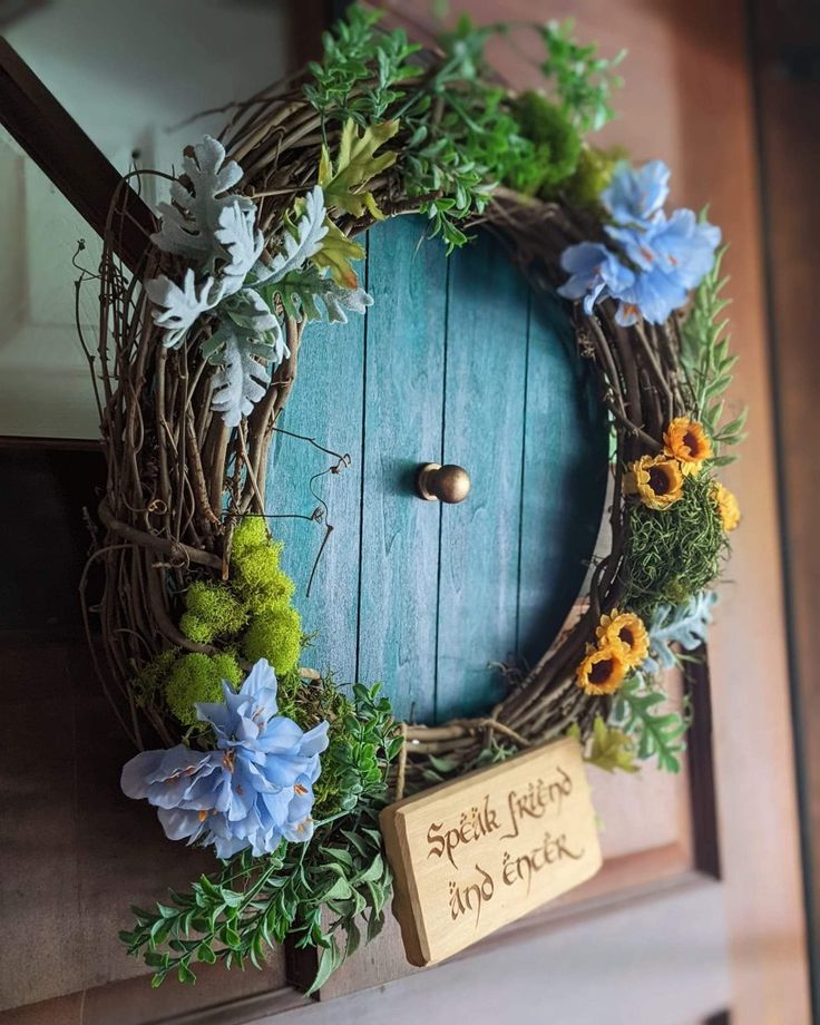 a wreath with flowers and a sign that says, spring begins at the end of the door