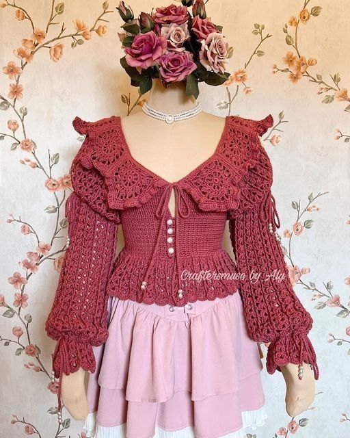 a mannequin wearing a red crochet top and pink skirt