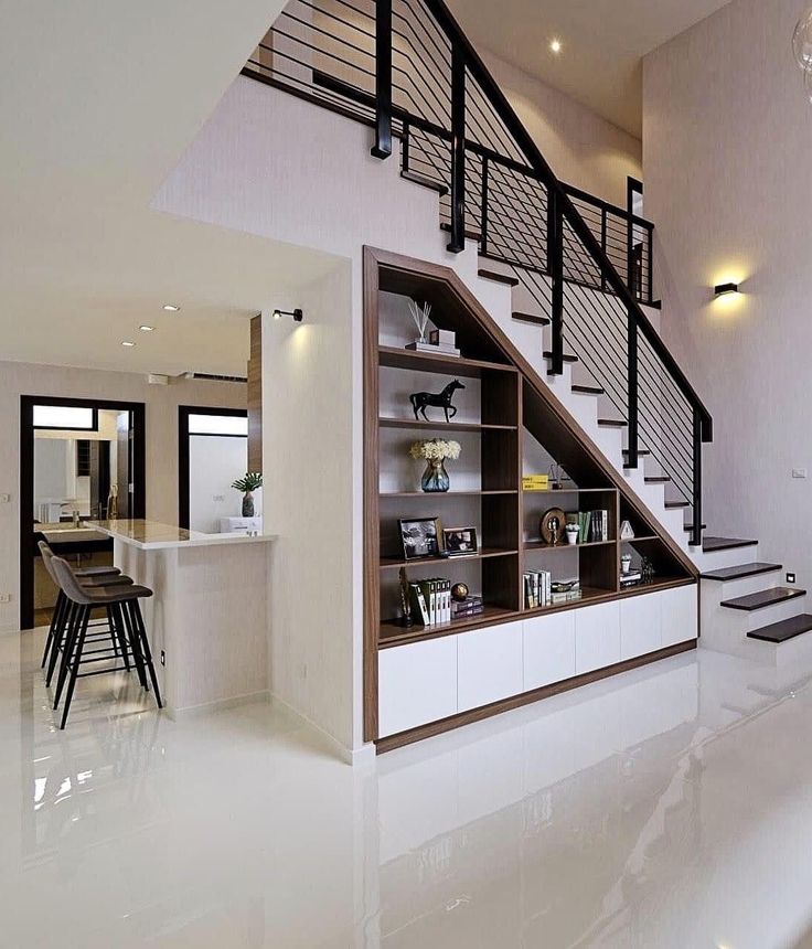 an open concept living room with stairs leading up to the second floor and dining area