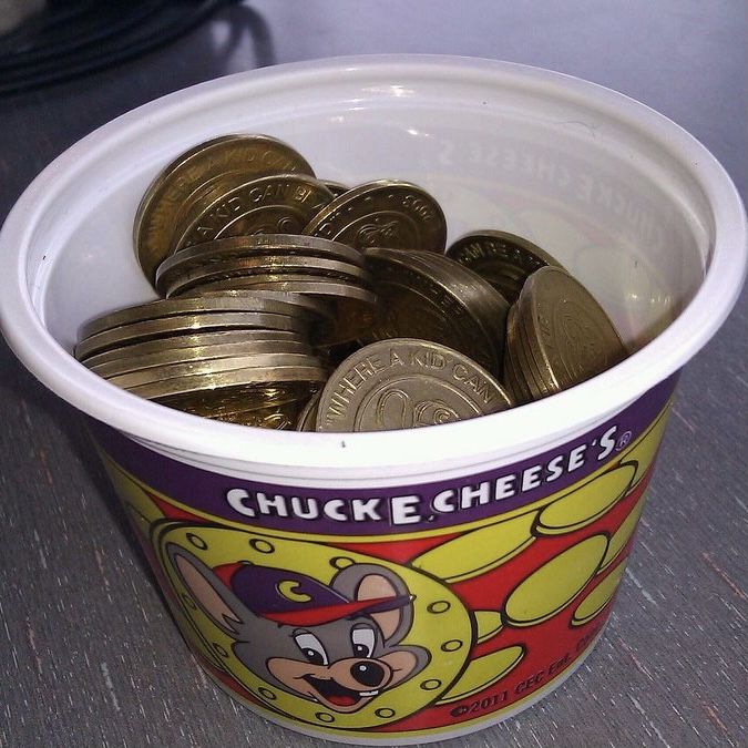 a bucket filled with coins sitting on top of a table