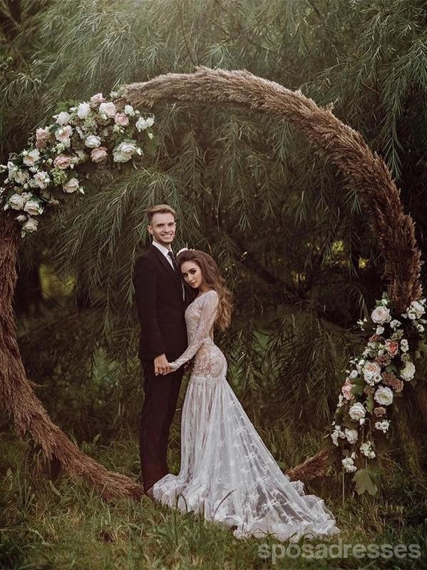 a man and woman standing in front of a circular wooden arch with flowers on it