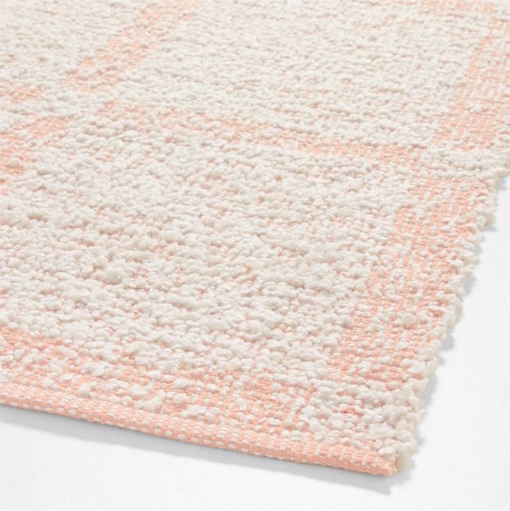 an orange and white rug on a white surface with no one in it or someone else