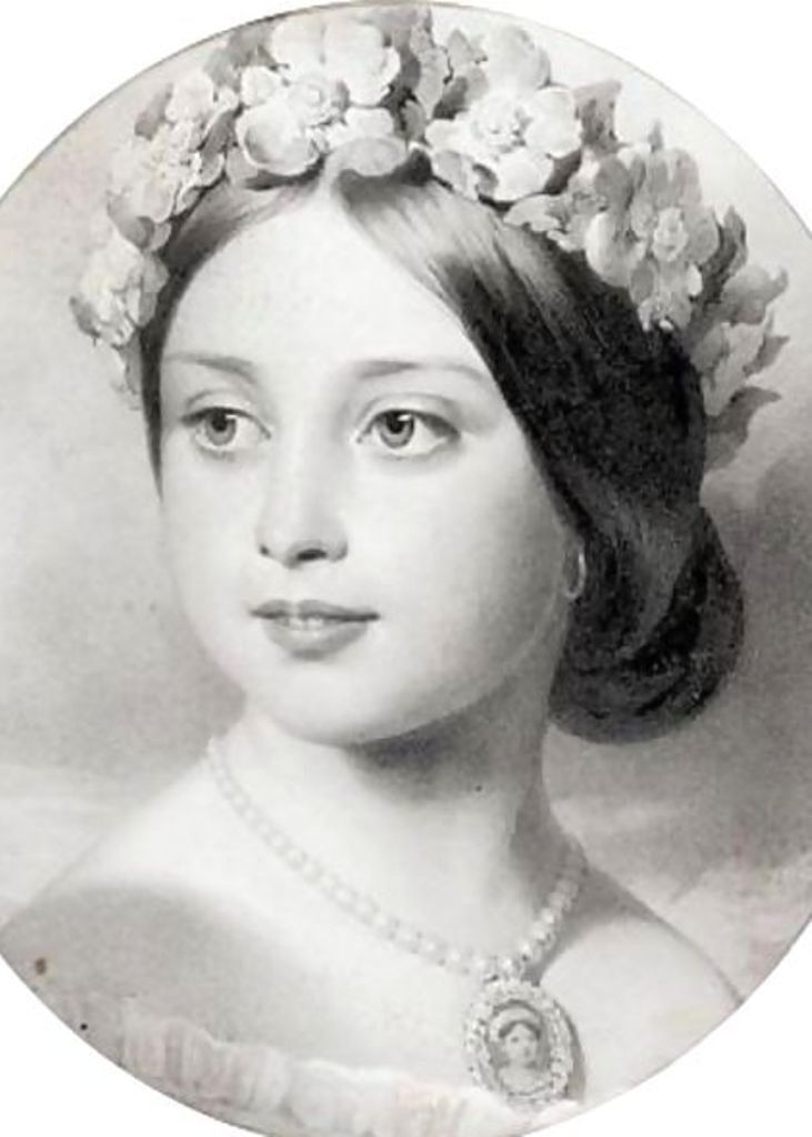 an old photo of a woman with flowers in her hair