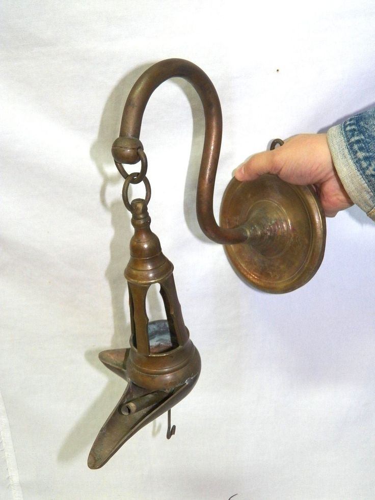 a person is holding an old fashioned tea kettle