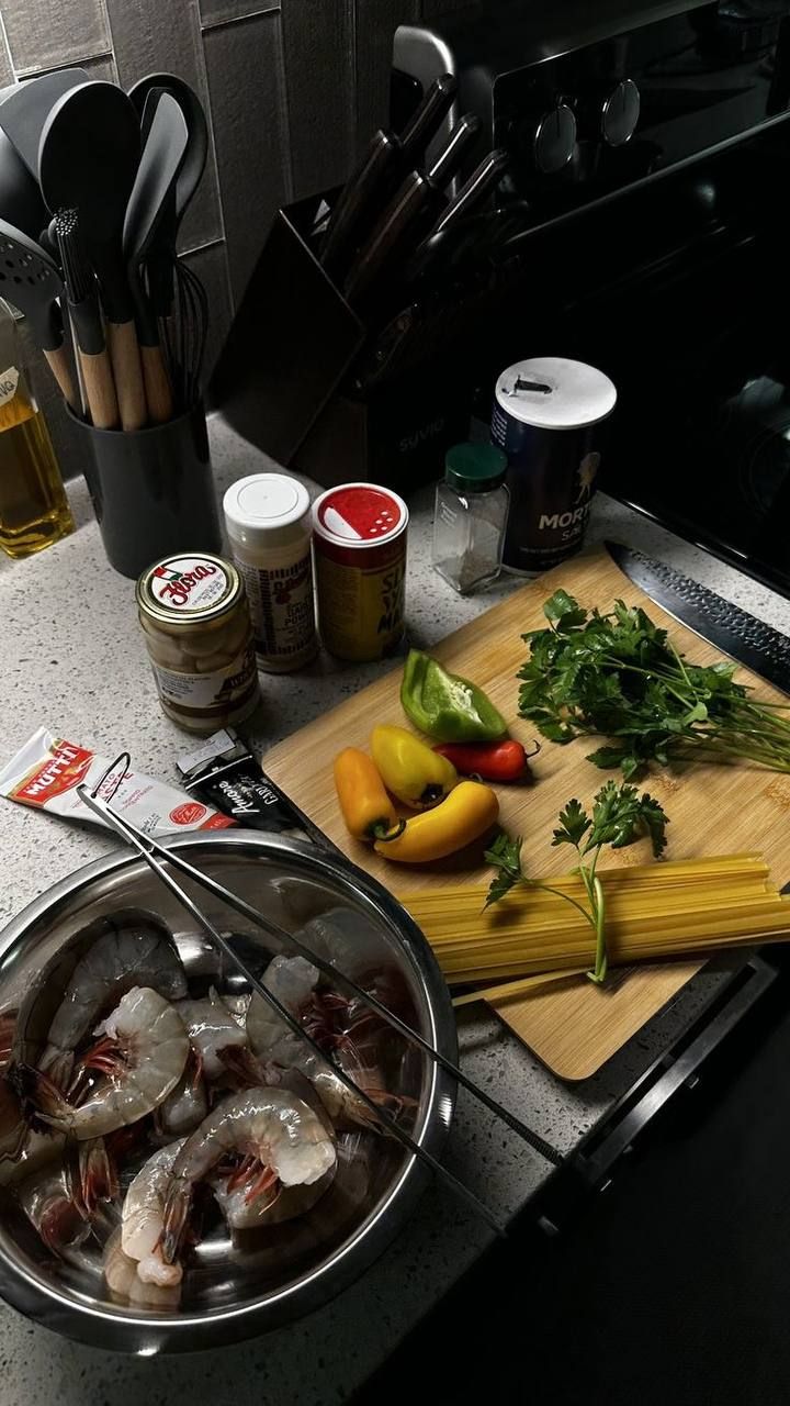 some food is laying out on the counter next to a cutting board and utensils