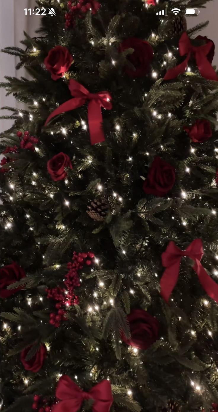 a christmas tree with red bows and lights