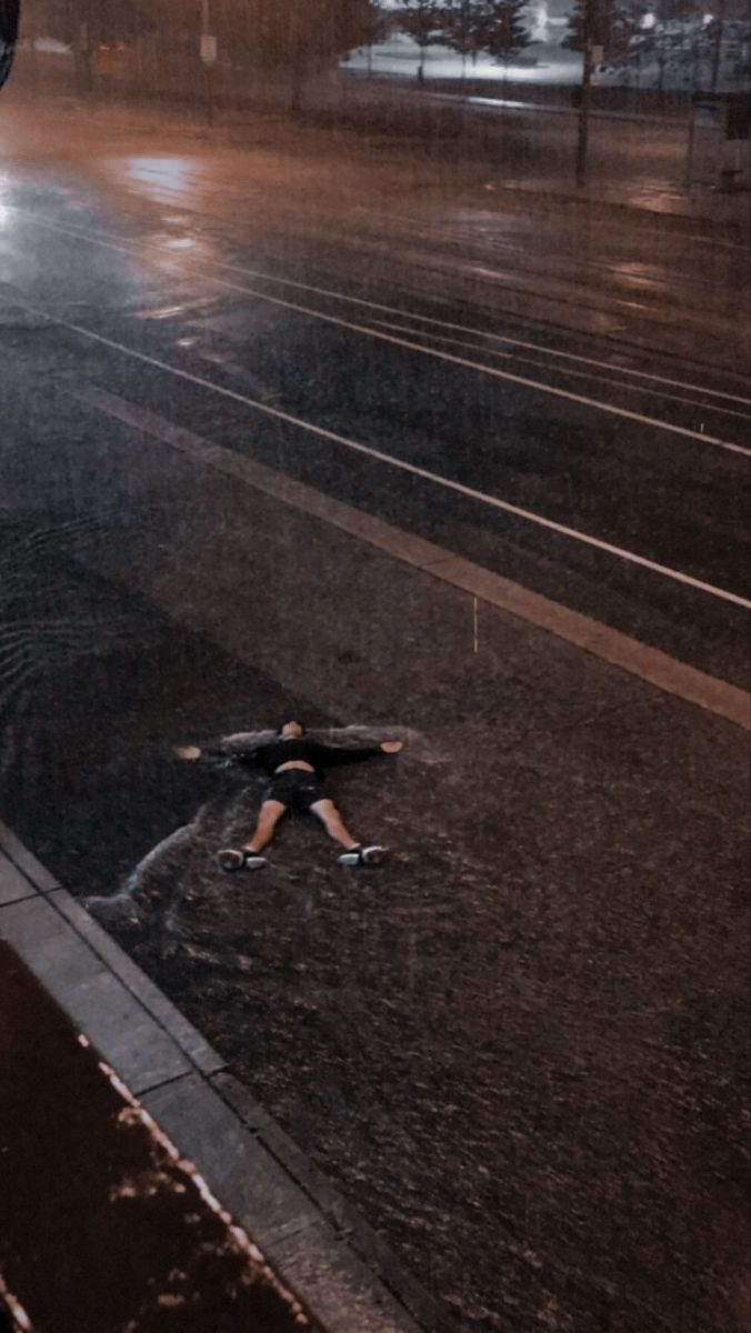 a person is walking down the street in the rain