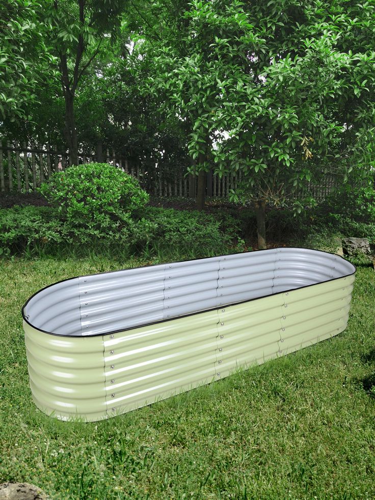 an oval shaped metal tub in the grass