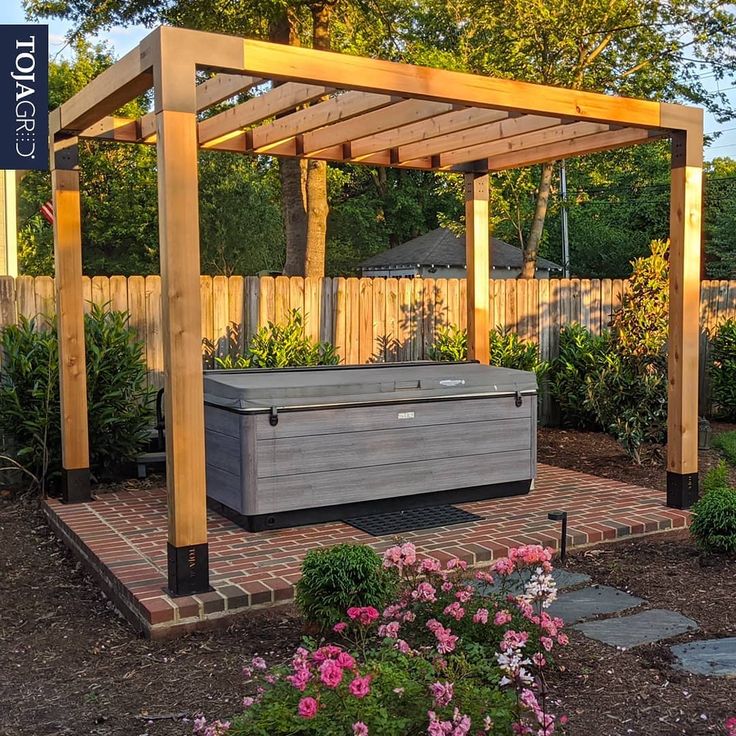 an outdoor hot tub in the middle of a garden