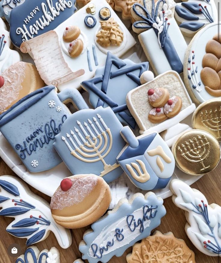 many decorated cookies are on a plate and one has a menorah in the middle