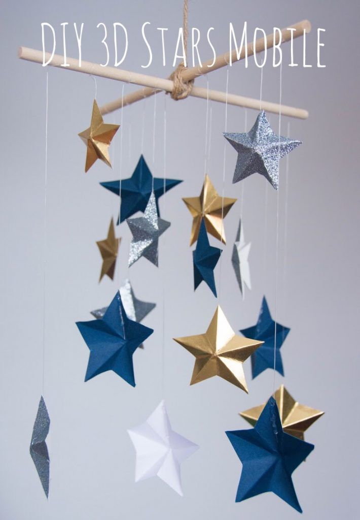 a mobile made out of paper stars hanging from a wooden stick with the words diy 3d stars mobile above it