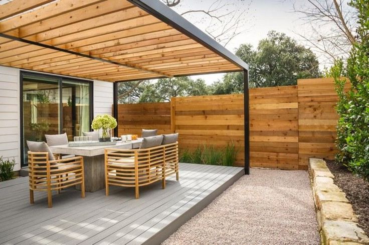 an outdoor dining area with wooden decking and patio furniture