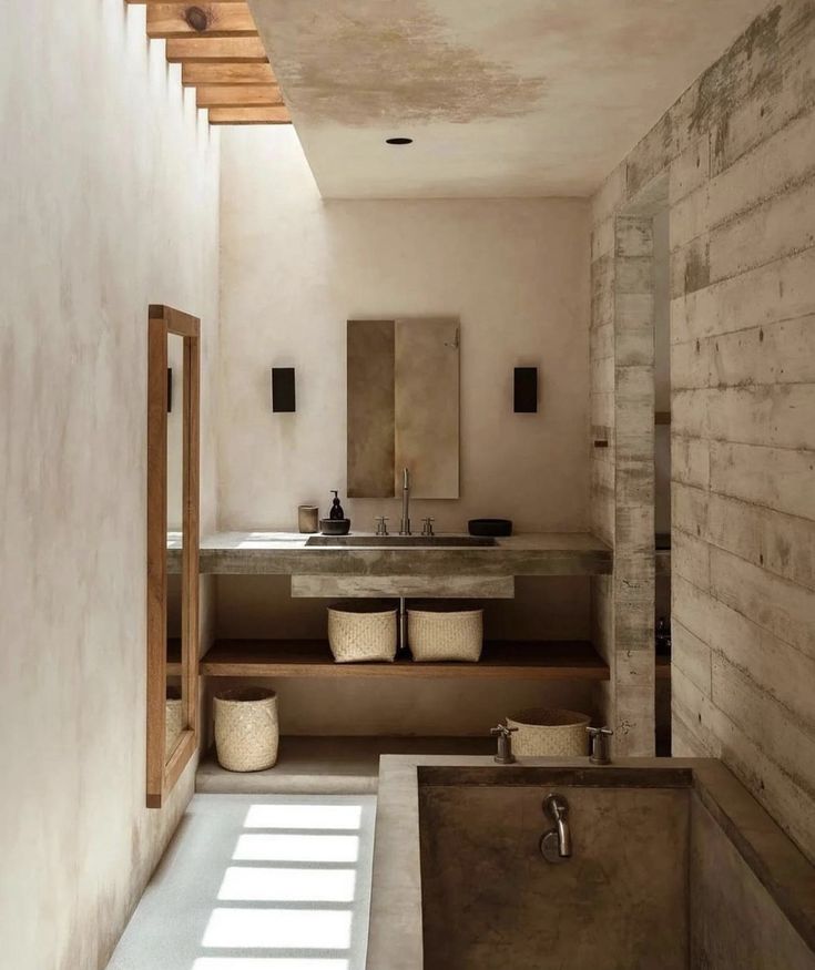 a bath room with a tub a sink and a mirror on the wall next to it