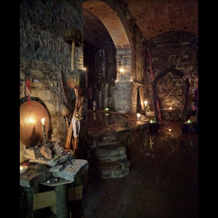 an old stone building with candles lit inside