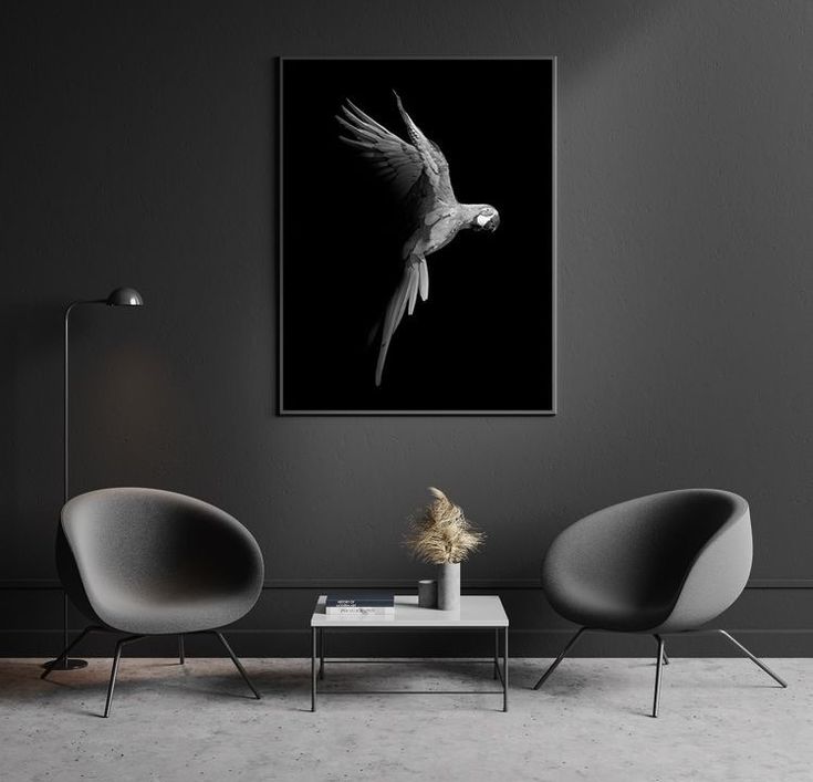 a living room with two chairs and a bird on the wall