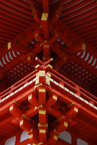 the top of a red and gold building