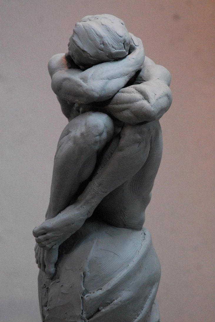 a sculpture of a person with their arms wrapped around his head and hands in the air