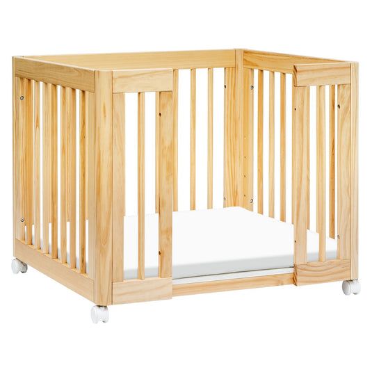 a wooden crib with a mattress on the bottom and side rails in front of it