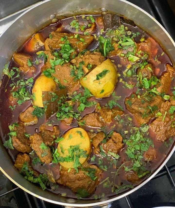 a pot filled with stew sitting on top of a stove