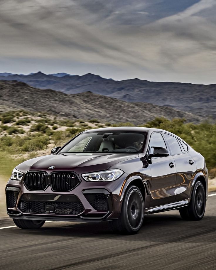 the bmw x4 is driving down the road