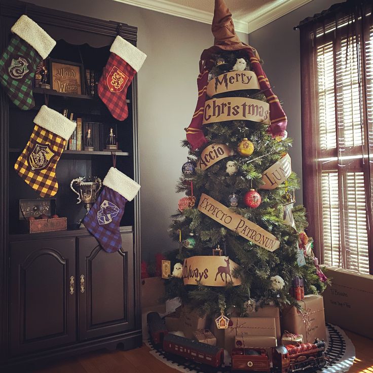 a christmas tree decorated with harry potter stockings