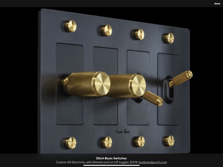 a black and gold wall mounted device with two different knobs on each one side