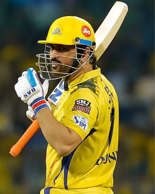 a man in a yellow uniform holding a bat and wearing a helmet with the number 22 on it