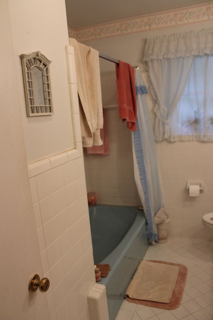 a bath tub sitting next to a toilet in a bathroom