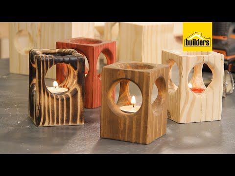 four wooden candle holders sitting on top of a table