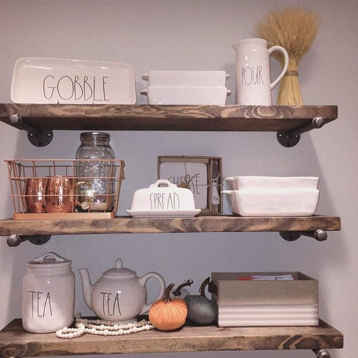 the shelves are filled with dishes and cups