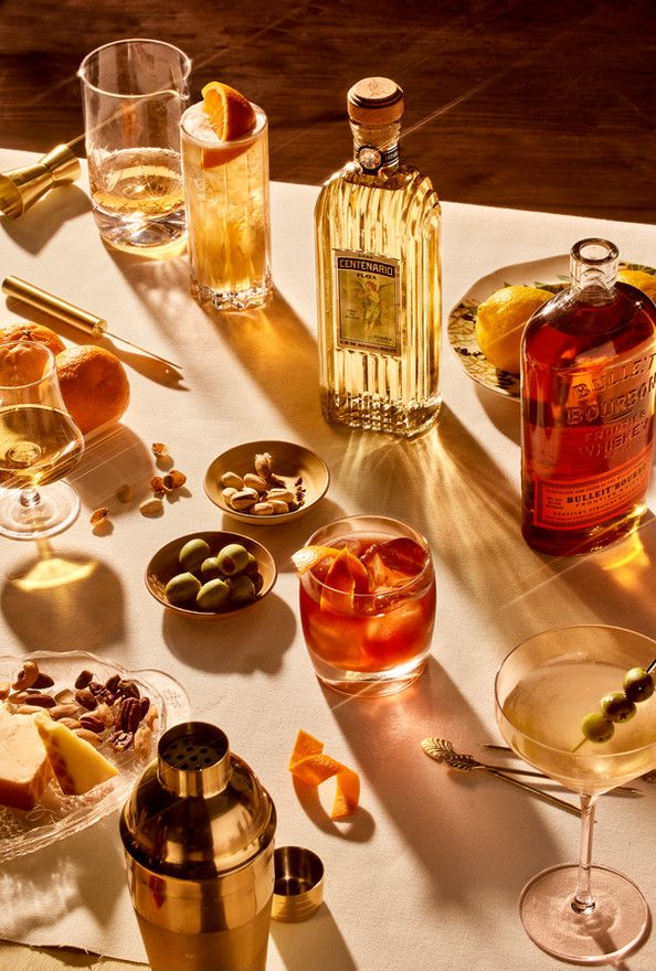 a table topped with glasses and bottles of alcohol