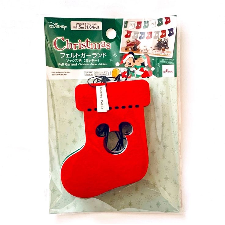 a red christmas stocking hanging from a package