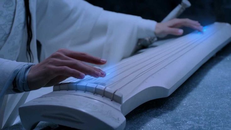 a close up of a person's hand on a musical instrument that appears to be playing