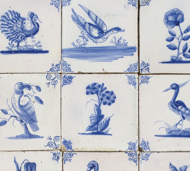 several blue and white tiles with birds, flowers, and plants on them are shown