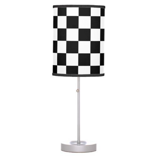 a black and white checkered lamp on a stand